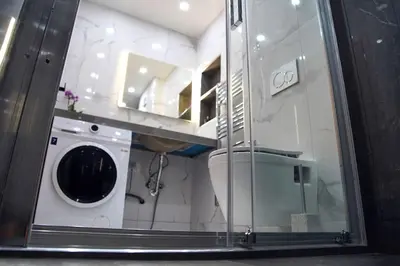 a bathroom with a washing machine in a room at Urban Elegance Retreat VIPGreece in Athens