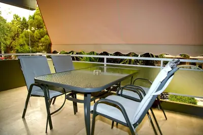 a table and chairs on top of a balcony at Urban Elegance Retreat VIPGreece in Athens