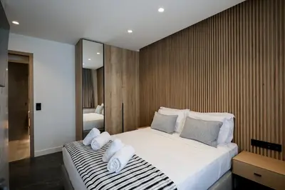 a bedroom with a large bed with towels on it at The Philosopher's Temple in Athens