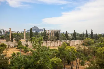 a view of the acropolis of athens from the trees at The Philosopher's Temple in Athens