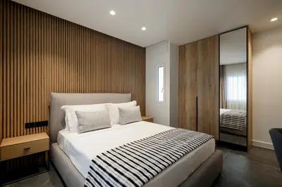 a bedroom with a large bed and a mirror at The Philosopher's Temple in Athens