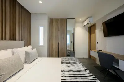a hotel room with a bed and a television at The Philosopher's Temple in Athens