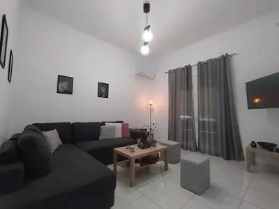 a living room with a couch and a table at The Grey House in Piraeus