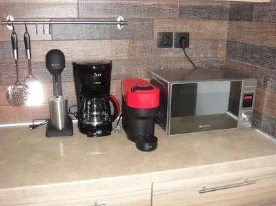 a kitchen counter with a microwave and a coffee maker at The Grey House in Piraeus