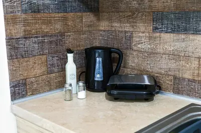 a coffee maker and a toaster sitting on a counter at The Grey House in Piraeus