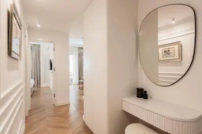 a white hallway with a mirror and a sink at Elegant apartment a breath away from the Acropolis in Athens