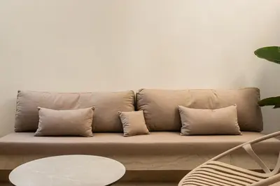 a couch with pillows and a table in a room at Elegant apartment a breath away from the Acropolis in Athens