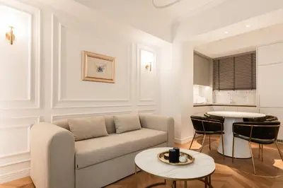 a living room with a couch and a table at Elegant apartment a breath away from the Acropolis in Athens