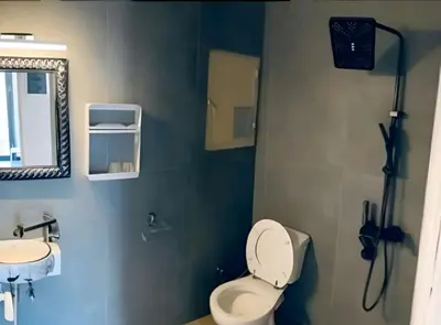 a bathroom with a toilet and a sink and a mirror at rpieras in Piraeus