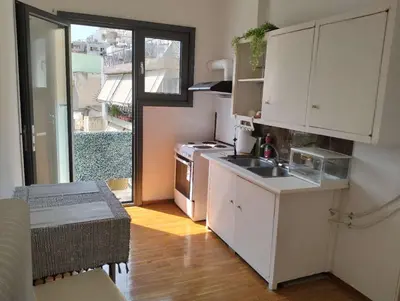 a small kitchen with a sink and a stove at rpieras in Piraeus