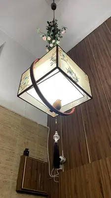 a light hanging from the ceiling in a living room at rpieras in Piraeus