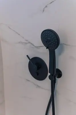 a hair dryer and a brush on a wall at Villa Poseidon Athens Riviera in Lagonissi