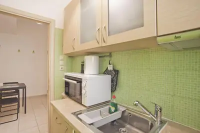 a kitchen with a sink and a microwave at Cozy Pagrati Nest Near Athens Center, AC, Wifi in Athens