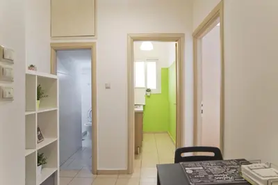 a kitchen with a dining table and a bathroom at Cozy Pagrati Nest Near Athens Center, AC, Wifi in Athens