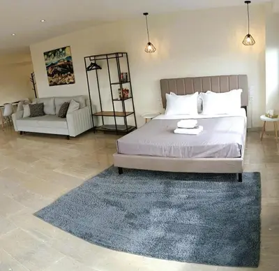 a bedroom with a bed with a rug and a couch at Athens Experience 2 in Athens