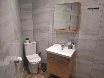 a bathroom with a toilet and a sink and a mirror at Athens Experience 2 in Athens