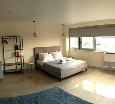 a bedroom with a bed and a large window at Athens Experience 2 in Athens