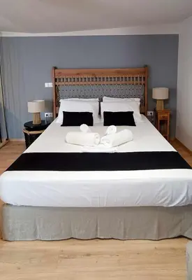 a large bed with two white towels on it at Gargaretta Suites Wildflower 4 Acropolis Museum District in Athens