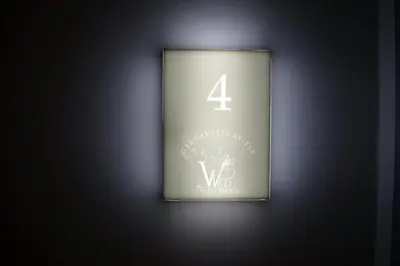 a sign with the number four on a wall at Gargaretta Suites Wildflower 4 Acropolis Museum District in Athens