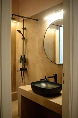 a bathroom with a black sink and a mirror at Gargaretta Suites Wildflower 4 Acropolis Museum District in Athens