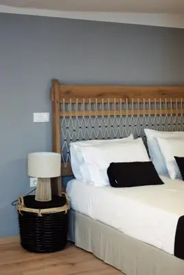 a bedroom with a bed with a headboard and a lamp at Gargaretta Suites Wildflower 4 Acropolis Museum District in Athens