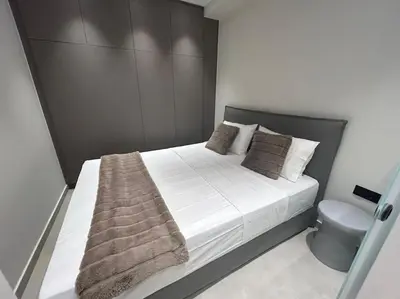 a bedroom with a large bed and a toilet at BlueMotion - Ferry 65 in Piraeus