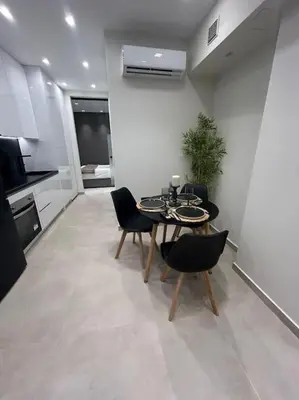 a dining room with a table and chairs in a kitchen at BlueMotion - Ferry 65 in Piraeus