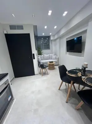 a living room with a couch and a table at BlueMotion - Ferry 65 #2 in Piraeus