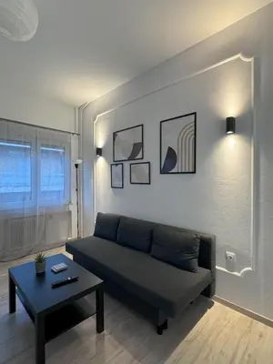 a living room with a couch and a table at Ntinos Apartment Center Exarcheia in Athens