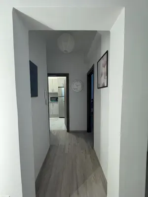 an empty hallway with white walls and wood floors at Ntinos Apartment Center Exarcheia in Athens