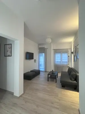 a living room with a couch and a table at Ntinos Apartment Center Exarcheia in Athens