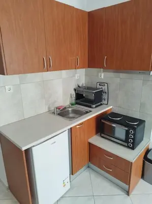 a small kitchen with a sink and a microwave at Small apartment in the heart of Piraeus! Notara 43 in Piraeus