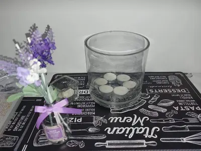 a glass vase with balls in it next to flowers at Small apartment in the heart of Piraeus! Notara 43 in Piraeus