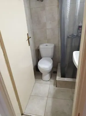 a small bathroom with a toilet and a sink at Small apartment in the heart of Piraeus! Notara 43 in Piraeus
