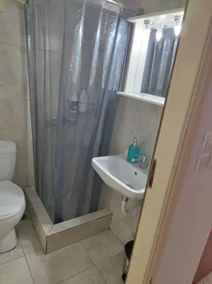 a bathroom with a shower and a sink and a toilet at Small apartment in the heart of Piraeus! Notara 43 in Piraeus