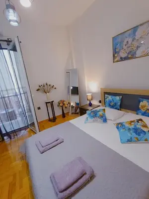 a bedroom with a large bed with two towels on it at Peacock in Athens