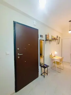 a large brown door in a room with a table at Peacock in Athens