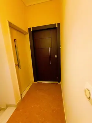 a black door in the corner of a room at Peacock in Athens