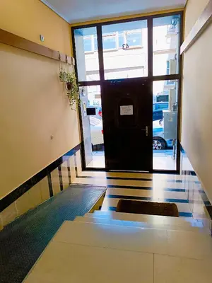 an empty hallway with a door to a parking garage at Peacock in Athens