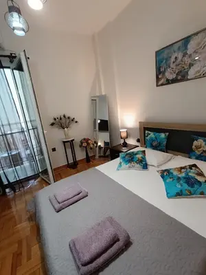 a bedroom with a large bed with two towels on it at Peacock in Athens