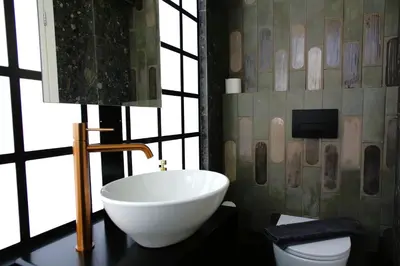 a bathroom with a white bowl sink and a lamp at Absolute Athens Acropolis Muses in Athens