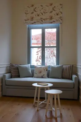 a living room with a couch and two tables at Absolute Athens Acropolis Muses in Athens