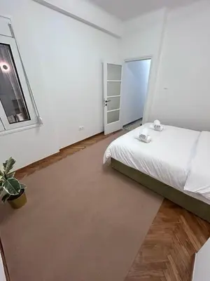 a white bedroom with a bed and a window at V32 - Athens Central Fully Equipped Apartment in Athens