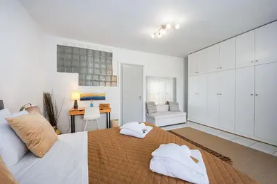 a bedroom with a large bed with towels on it at Villa Costa Luca in Vouliagmeni in Athens