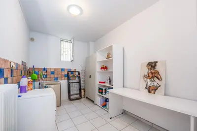 a white kitchen with a sink and a refrigerator at Villa Costa Luca in Vouliagmeni in Athens