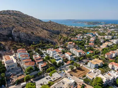 an aerial view of a city with the ocean at Villa Costa Luca in Vouliagmeni in Athens