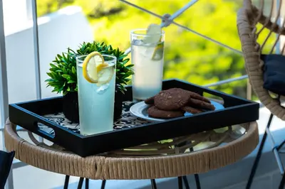 a tray of food on a table with drinks and cookies at Villa Costa Luca in Vouliagmeni in Athens