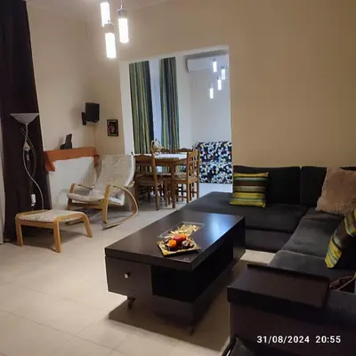 a living room with a couch and a table at Skyline Serenity in Lagonissi