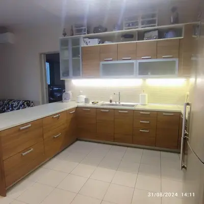 a kitchen with wooden cabinets and a sink at Skyline Serenity in Lagonissi