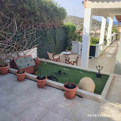a garden with potted plants on a patio at Skyline Serenity in Lagonissi